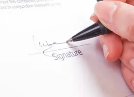 Woman signing paperwork