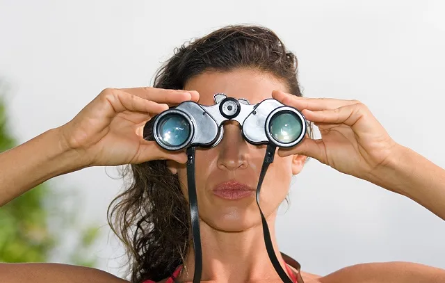 Woman looking through binoculars